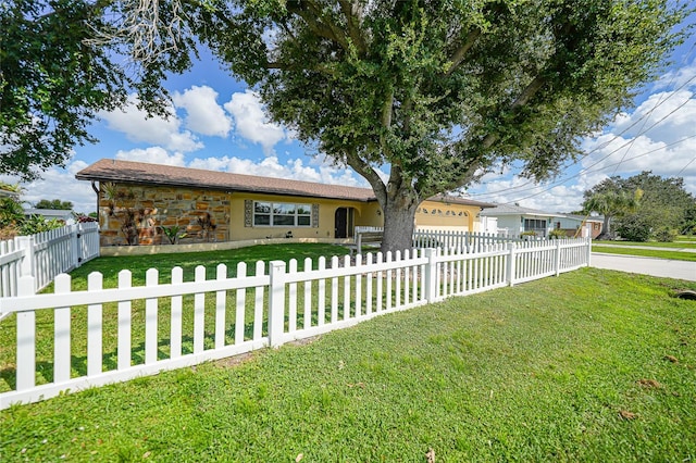 ranch-style home featuring a front yard and a garage