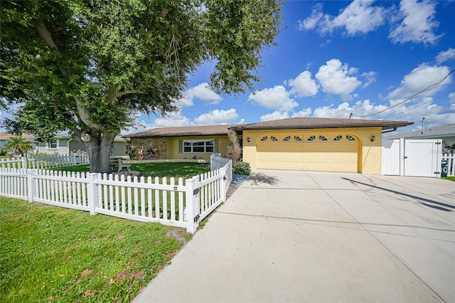 single story home featuring a front lawn and a garage