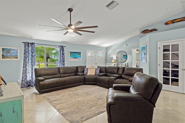 tiled living room featuring ceiling fan, vaulted ceiling, and french doors