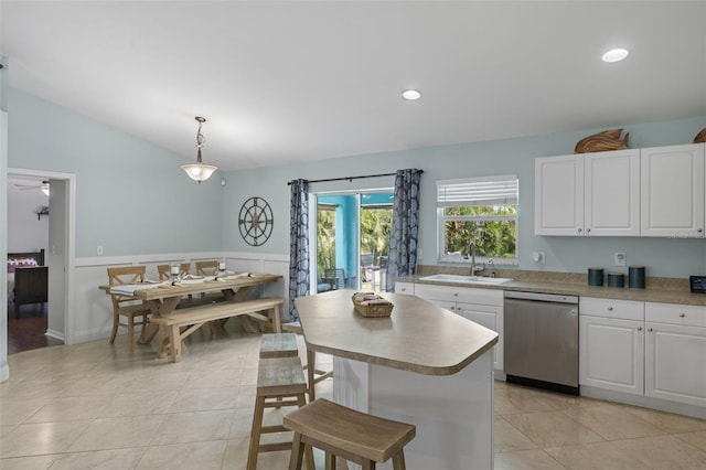 kitchen featuring white cabinetry, dishwasher, decorative light fixtures, and sink