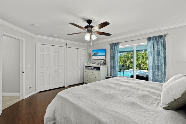 bedroom with access to exterior, ceiling fan, dark hardwood / wood-style floors, crown molding, and two closets