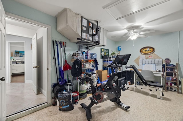 exercise area featuring ceiling fan and light tile patterned floors