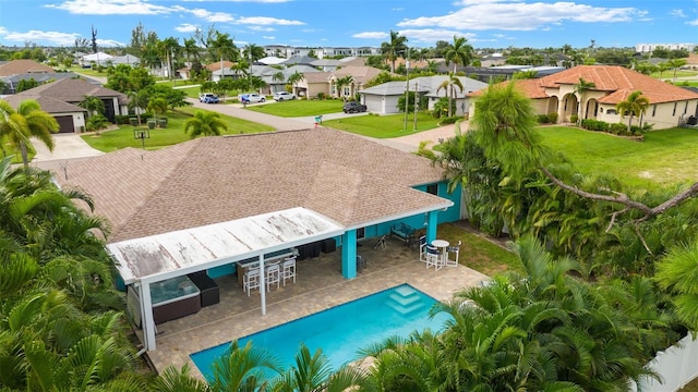 view of pool featuring an outdoor living space, a bar, a patio, and a yard