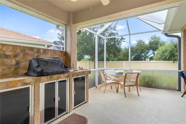 sunroom featuring ceiling fan