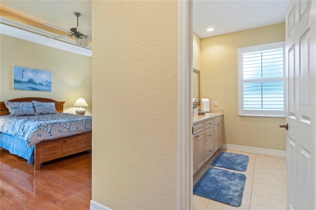 bedroom with ceiling fan and light hardwood / wood-style floors