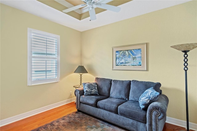 living room with ceiling fan and dark hardwood / wood-style flooring