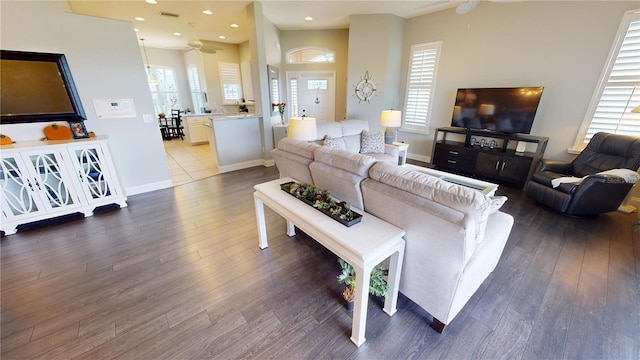 living room featuring ceiling fan, plenty of natural light, and hardwood / wood-style floors