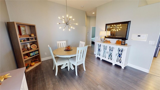 dining room with a notable chandelier, hardwood / wood-style floors, and a high ceiling