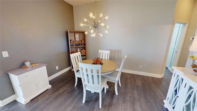 dining space with dark wood-type flooring and a notable chandelier