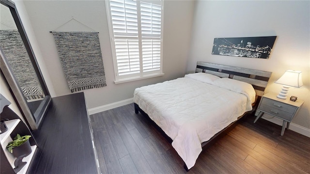 bedroom with dark hardwood / wood-style floors