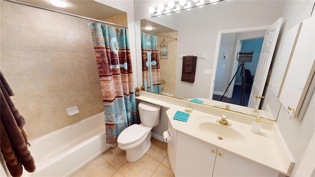 full bathroom featuring vanity, shower / bath combo with shower curtain, toilet, and tile patterned flooring