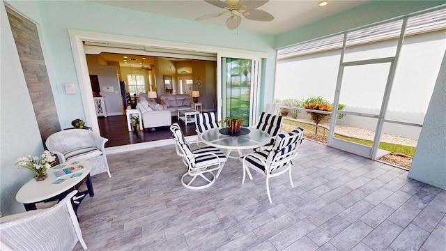 sunroom featuring ceiling fan