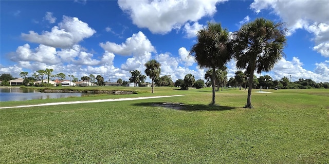 view of community with a lawn and a water view