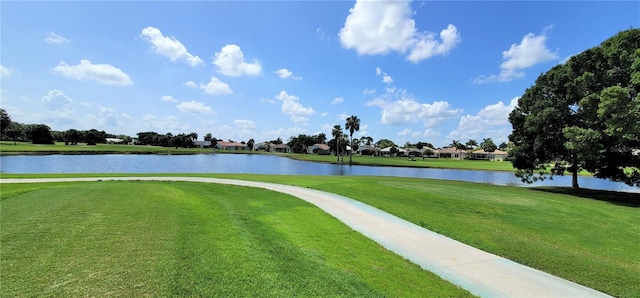 view of community featuring a lawn and a water view