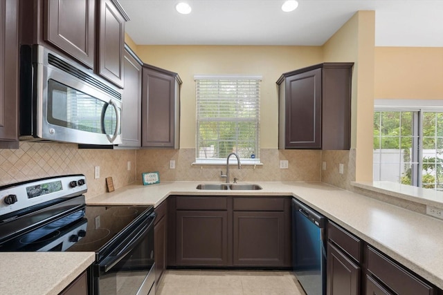 kitchen featuring stainless steel appliances, plenty of natural light, tasteful backsplash, and sink