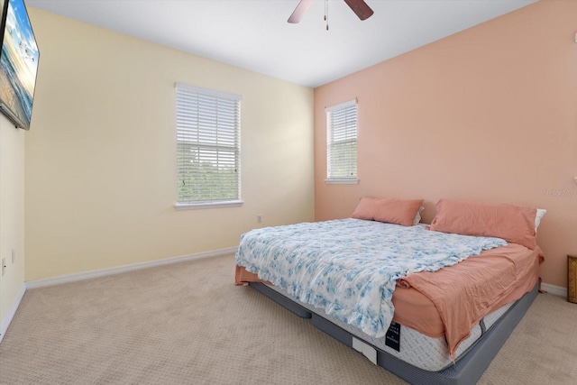 bedroom with ceiling fan and light colored carpet