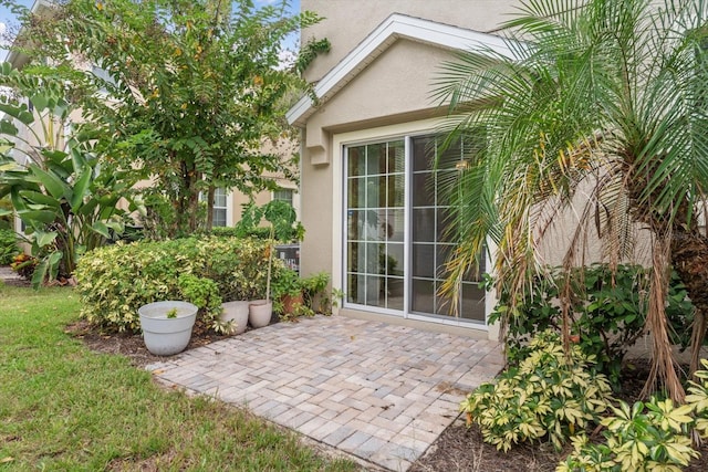 view of exterior entry featuring a patio