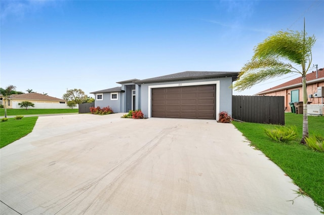 ranch-style house featuring a front lawn and a garage