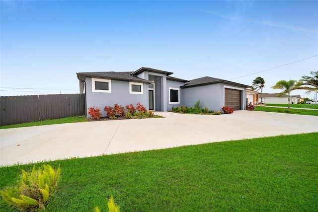 view of front facade with a garage and a front lawn