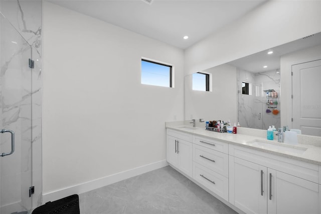 bathroom with vanity and a shower with shower door