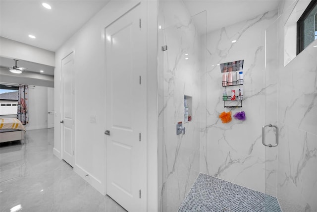 bathroom featuring a shower with door and ceiling fan