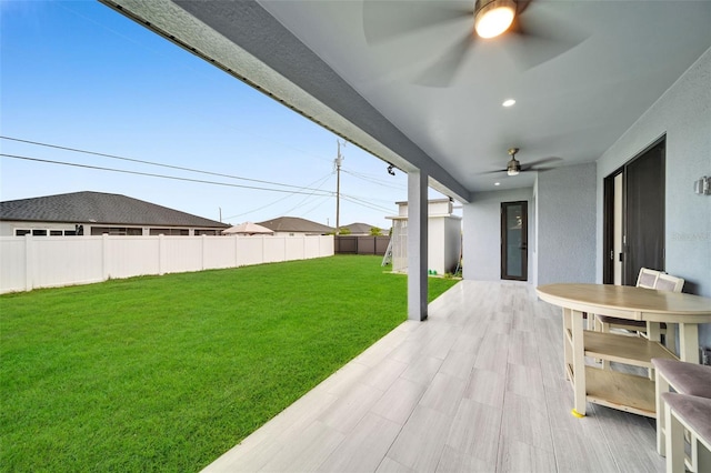 exterior space with ceiling fan and a patio area