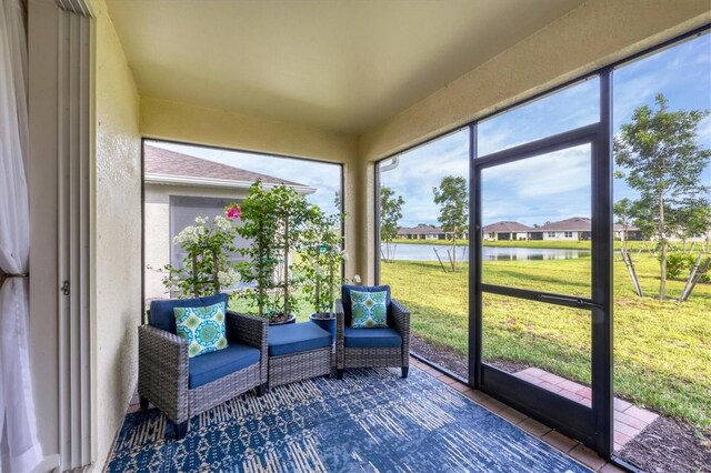 unfurnished sunroom with a water view