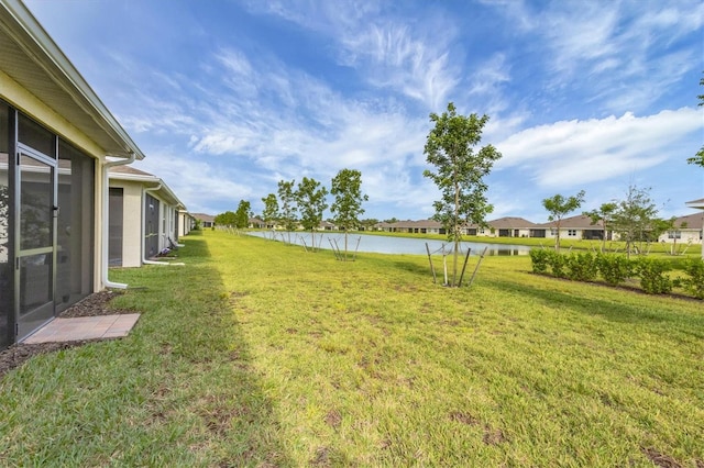 view of yard with a water view and a residential view