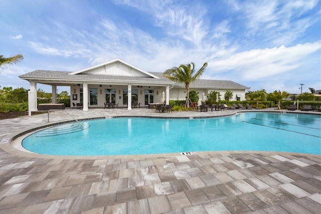 pool with a patio area and ceiling fan