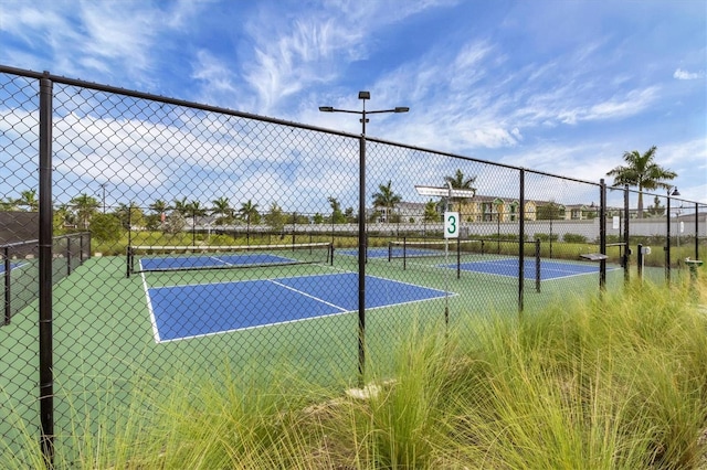 view of sport court with fence