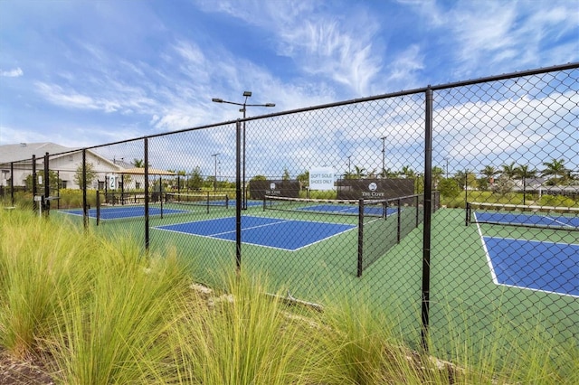 view of tennis court featuring fence