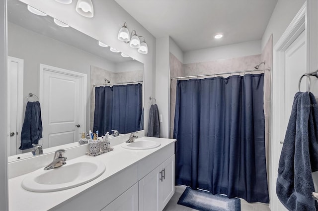 full bath with a sink, a shower with shower curtain, and double vanity