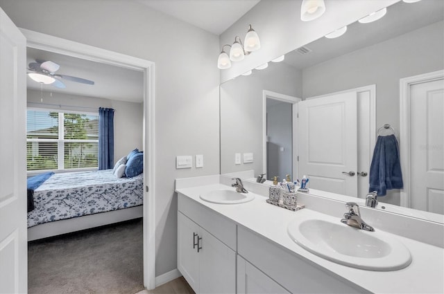 ensuite bathroom with double vanity, ceiling fan, a sink, and ensuite bathroom