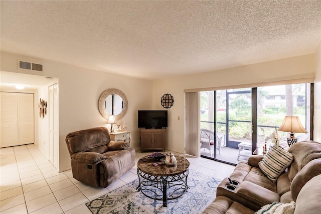 tiled living room featuring a textured ceiling