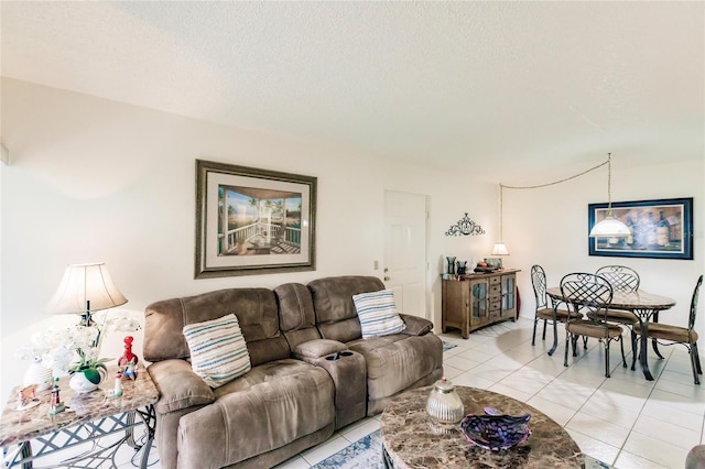 living room featuring a textured ceiling and light tile patterned floors