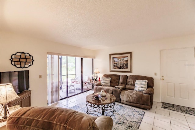 living room featuring a textured ceiling and light tile patterned floors