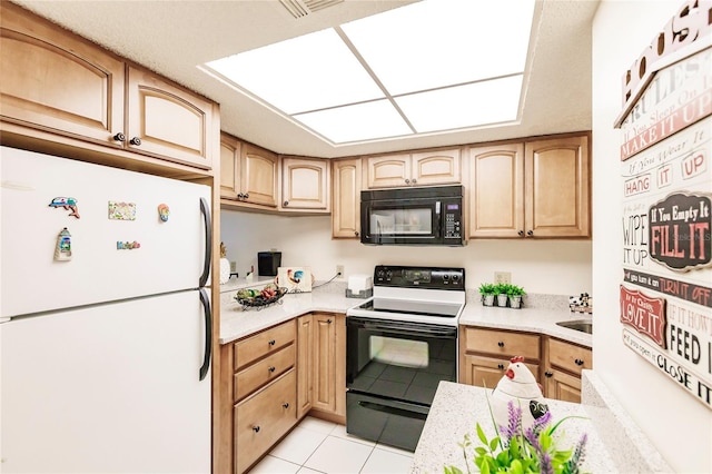 kitchen featuring white appliances, light brown cabinets, and light tile patterned floors