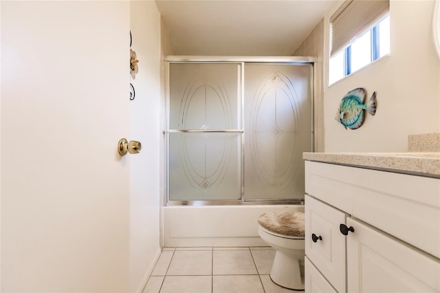 full bathroom with vanity, tile patterned flooring, toilet, and combined bath / shower with glass door