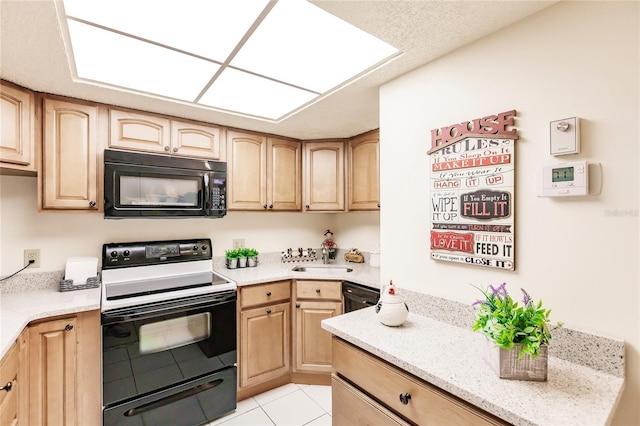 kitchen with black appliances, light brown cabinets, light tile patterned floors, and sink