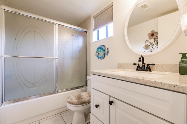 full bathroom with enclosed tub / shower combo, vanity, tile patterned flooring, and toilet