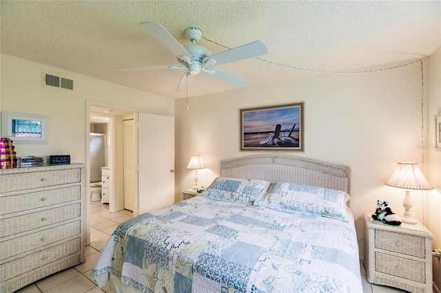 bedroom featuring ceiling fan, a textured ceiling, and light tile patterned floors