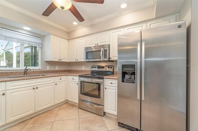 kitchen with ceiling fan, sink, light tile patterned floors, white cabinets, and appliances with stainless steel finishes