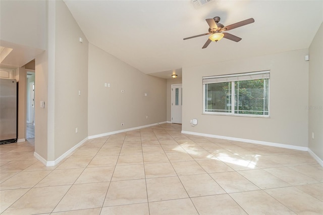 empty room featuring ceiling fan and light tile patterned floors