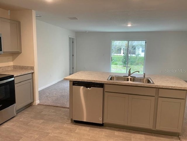 kitchen with gray cabinets, light colored carpet, sink, and stainless steel appliances