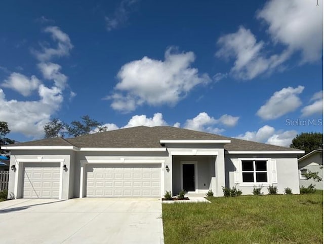 view of front of property featuring a garage and a front lawn