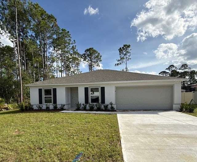 ranch-style home featuring a garage and a front lawn