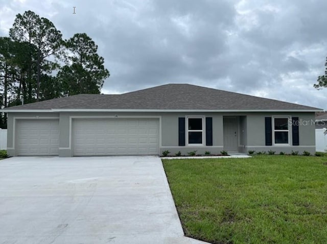 view of front of house featuring a front yard and a garage