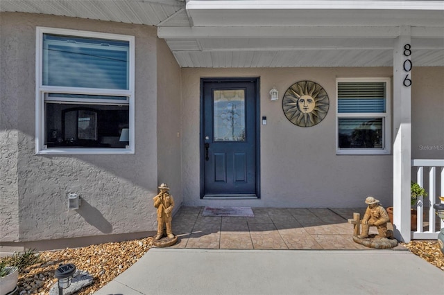 view of exterior entry with a porch