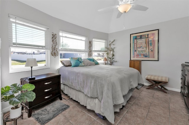 bedroom featuring multiple windows, light tile patterned floors, and ceiling fan