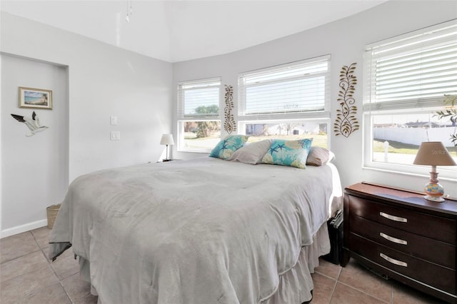 tiled bedroom featuring multiple windows